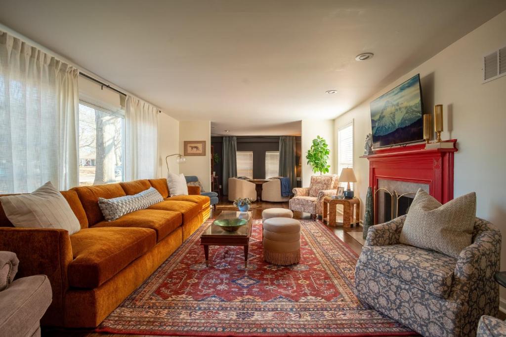 a living room with a couch and a fireplace at Eden at Blue Lane in Olathe