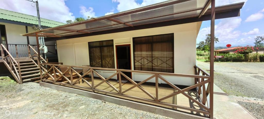 a small house with a porch and a balcony at Casa el Corral #2 in Aguacate
