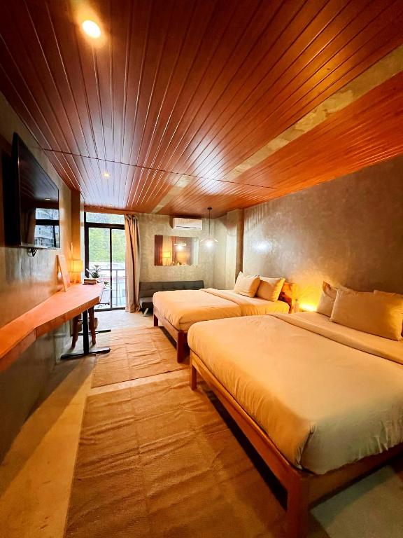 a bedroom with two beds in a room at Island Pod in El Nido