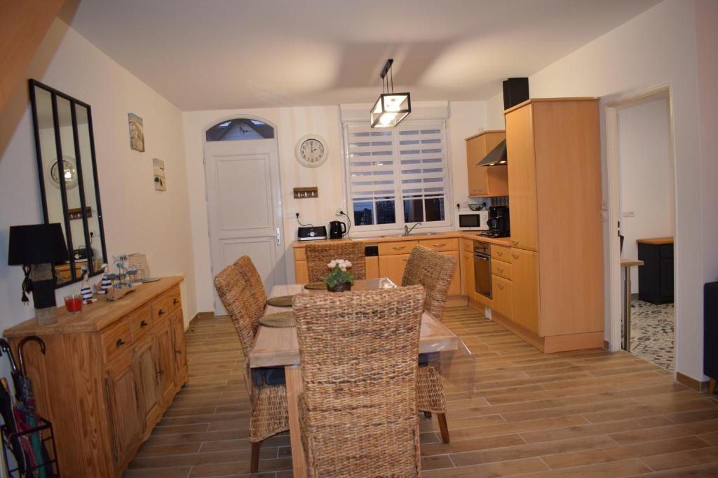 a kitchen and dining room with a table and chairs at brise marine in Le Crotoy