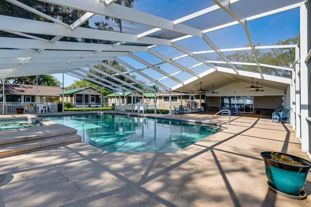 a swimming pool with a retractable pergola over it at Lake View, Pool Access! Pet-Friendly Hernando Stay in Hernando