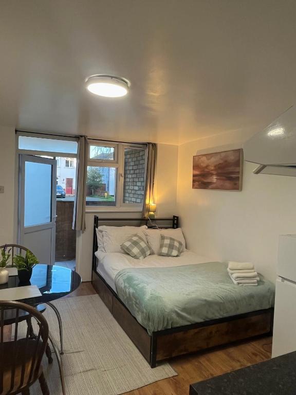 a small bedroom with a bed and a window at Studio near Addenbrookes and Centre By Miller Residence in Cherry Hinton