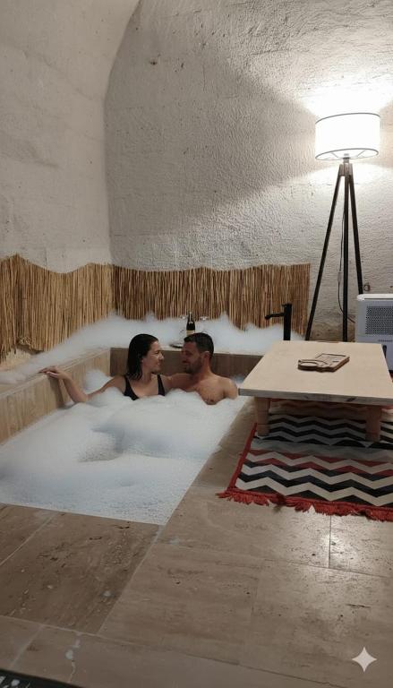 a man and a woman sitting in a hot tub at Route Cappadocia in Avanos