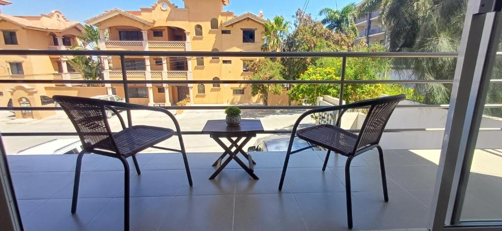 two chairs and a table on a balcony at Condo Sunset in Cabo San Lucas