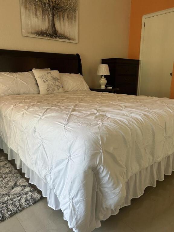 a large white bed in a bedroom with a lamp at Zoë Oasis - #1 Couple's Choice & Wholesome Getaway in Lilliendahl
