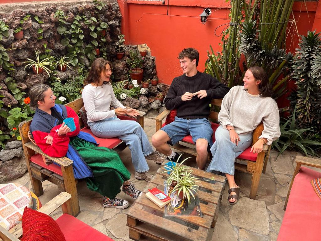 a group of people sitting in chairs on a patio at Econunay Hostels in Arequipa