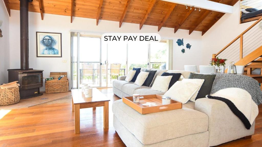 a living room with a couch and a table at Summerwood in Flinders