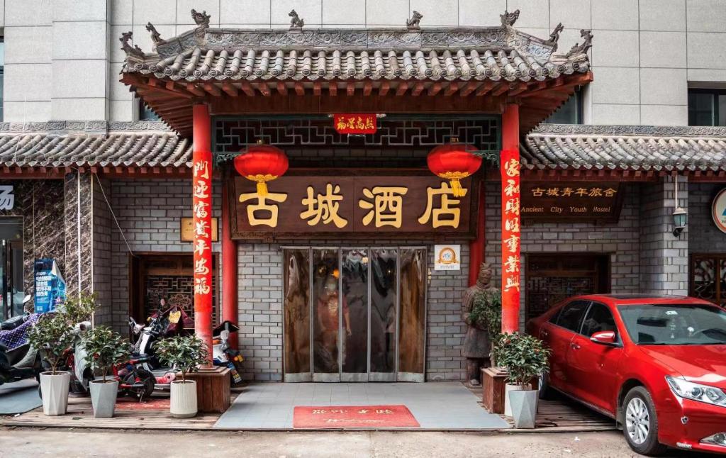 a red car parked in front of a building at 古城青年旅舍 in Xi'an