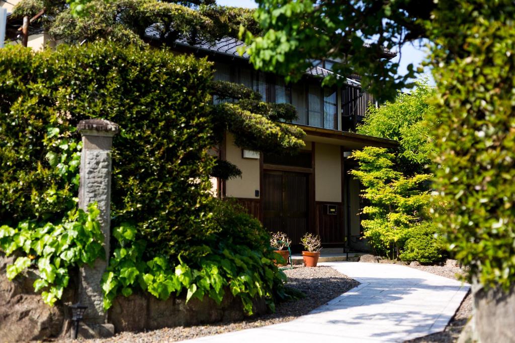 a house with a stone pillar in front of it at ootaryokan in Kuroki