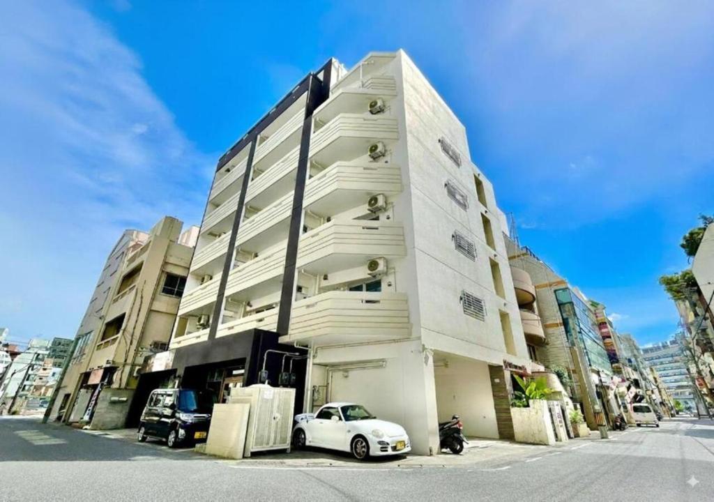 a white car parked in front of a building at Villa Izumizaki in Naha