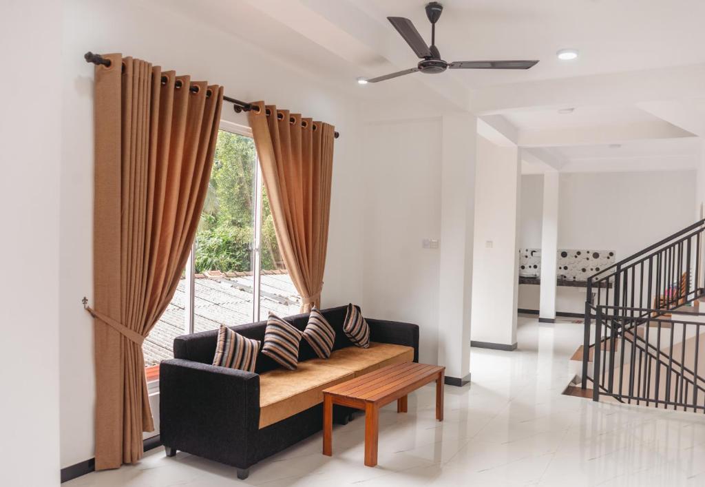 a living room with a couch and a window at Heaven inn Hotel, Digana in Digana