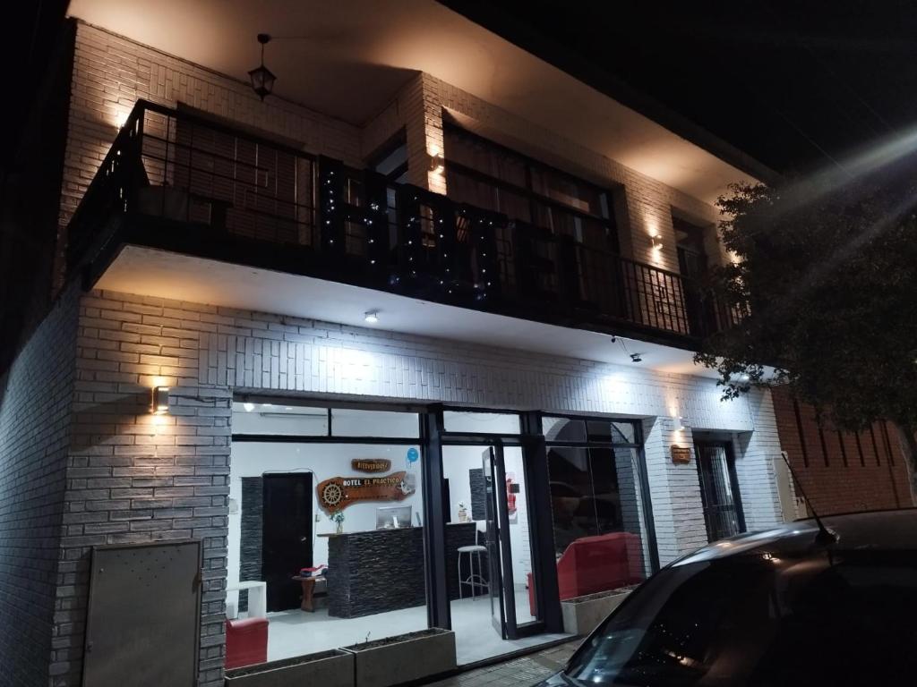 a building with a balcony on top of it at Hotel Graciela in Villa Carlos Paz