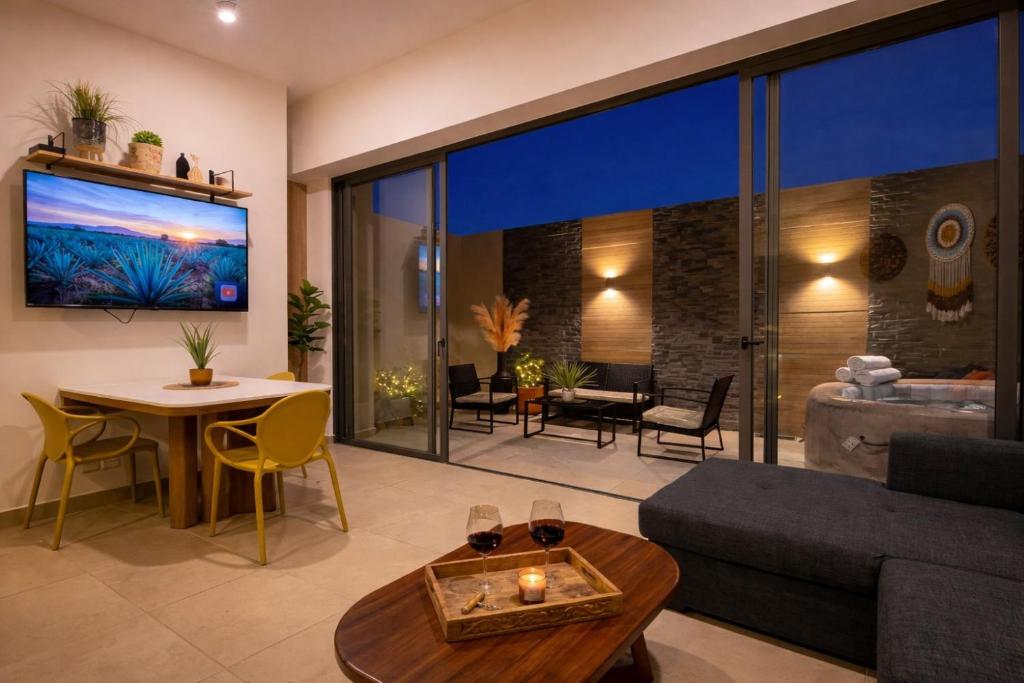 a living room with a couch and a table at Depto nuevo de lujo en PB|Terraza con jacuzzi |Gym in Guadalajara