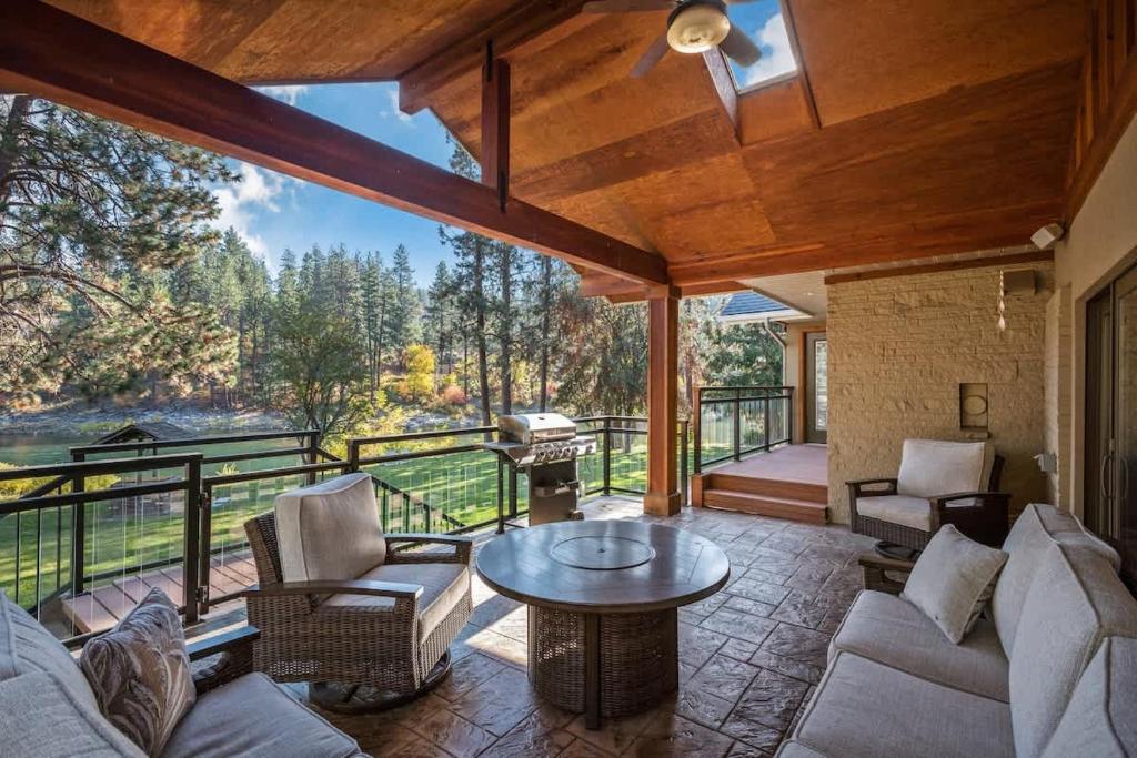 a living room with a couch and chairs and a table at Private Riverfront Estate with Kayaks & Views in Post Falls