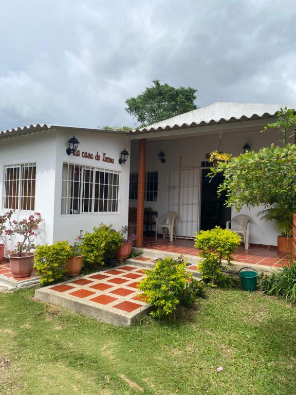 a white house with a red and white brick walkway at La Casa de Luzma in Pueblo Bello