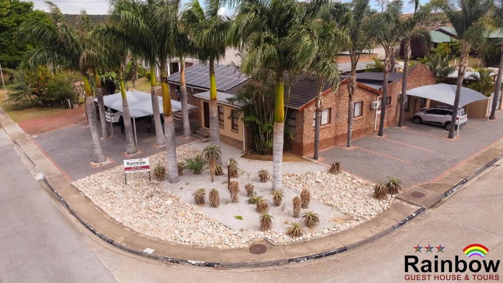 a model of a house with palm trees in front of it at Rainbow Guest House and Tours in Uitenhage