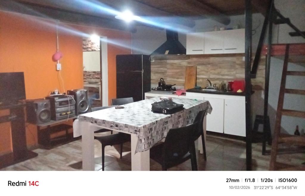 a kitchen with a table and chairs in a room at La casa de Anto in Tanti