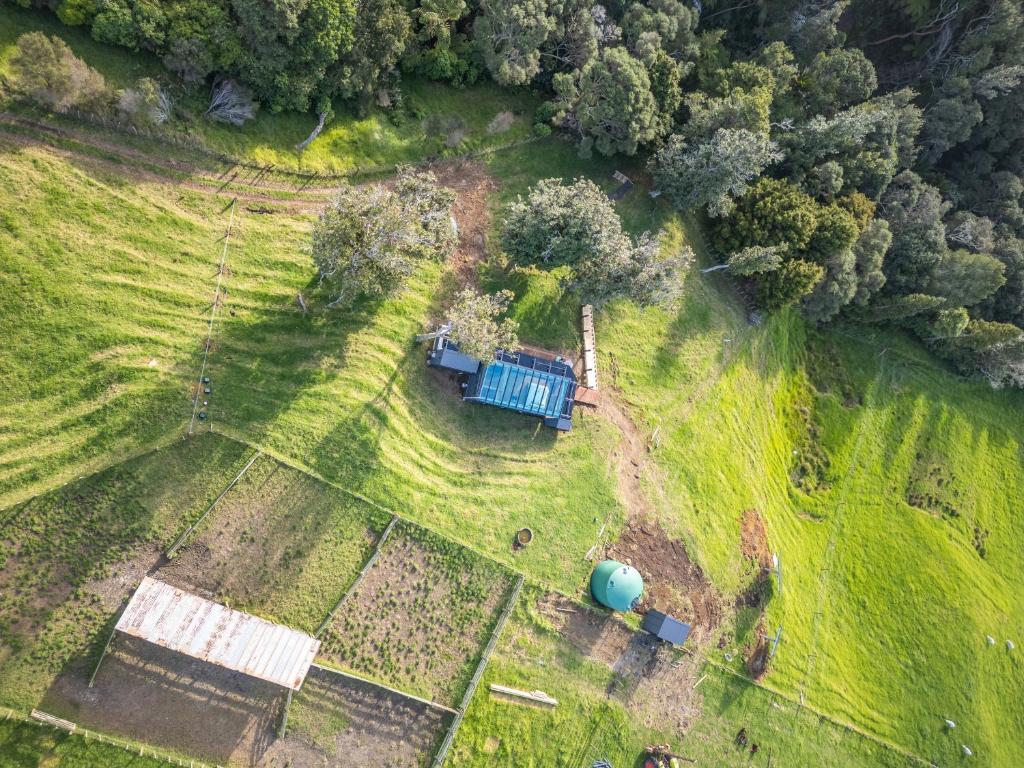 an aerial view of a farm with a silo at Rewarewa PurePod in Helensville