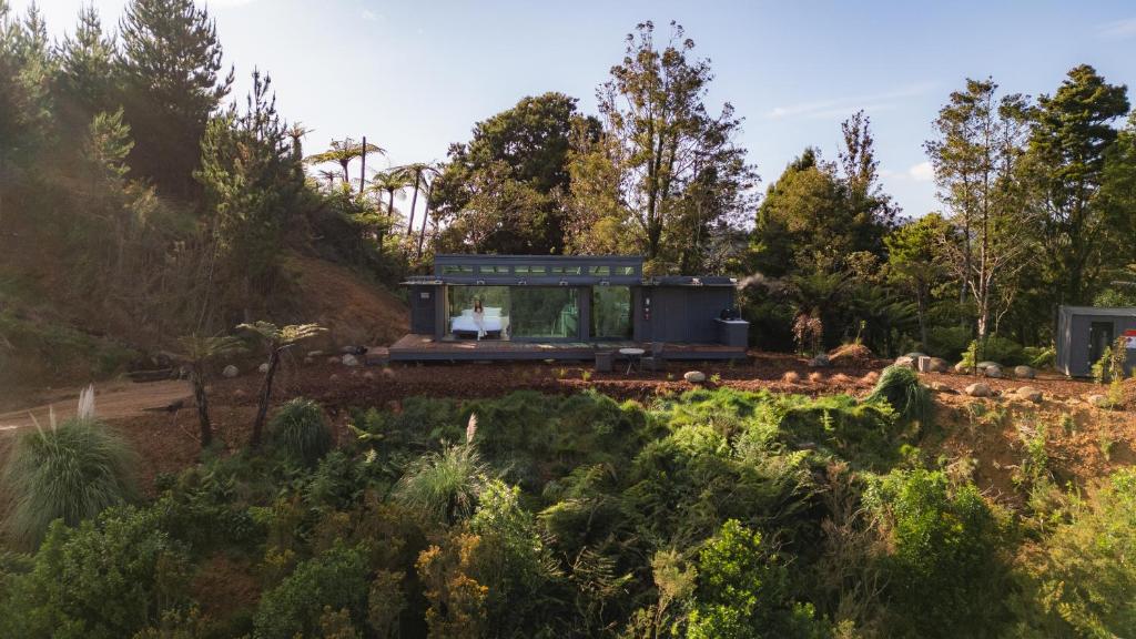a house in the middle of a garden at Ruru PurePod in Waikino