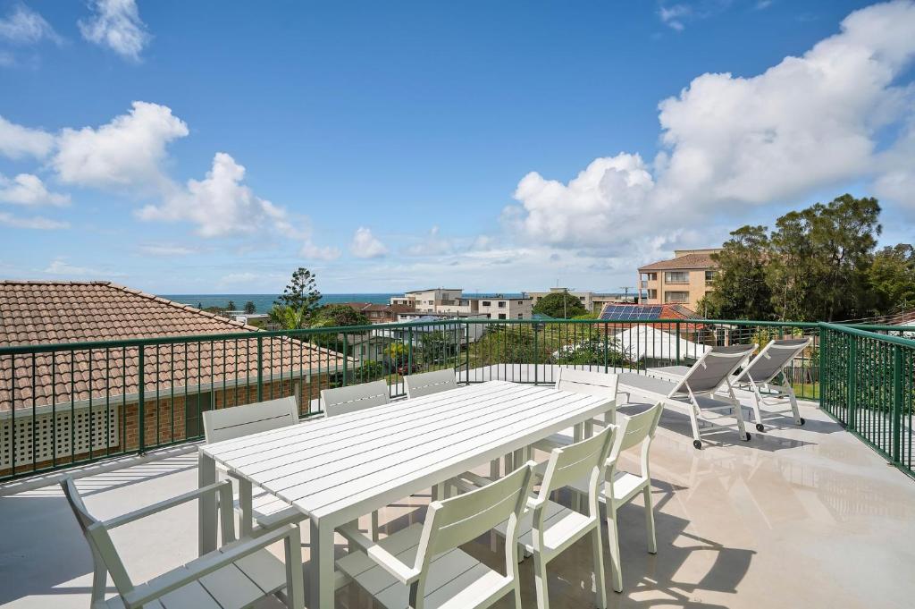 a white table and chairs on a balcony at Seychelle unit 5 Kings Beach in Caloundra