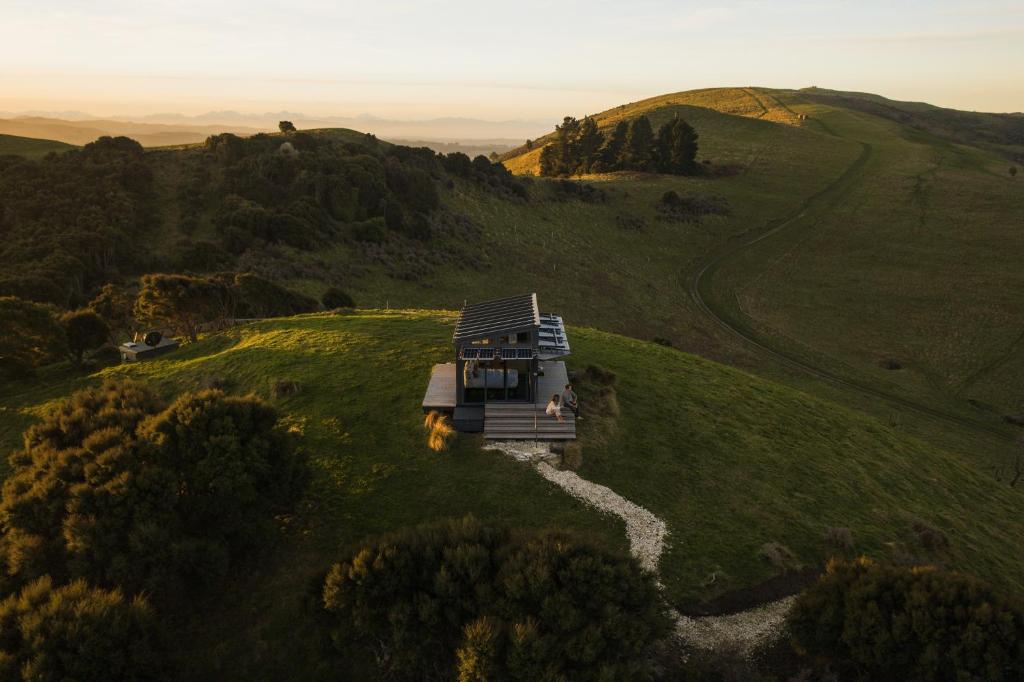 an aerial view of a house on a hill at Atatū PurePod in Tormore