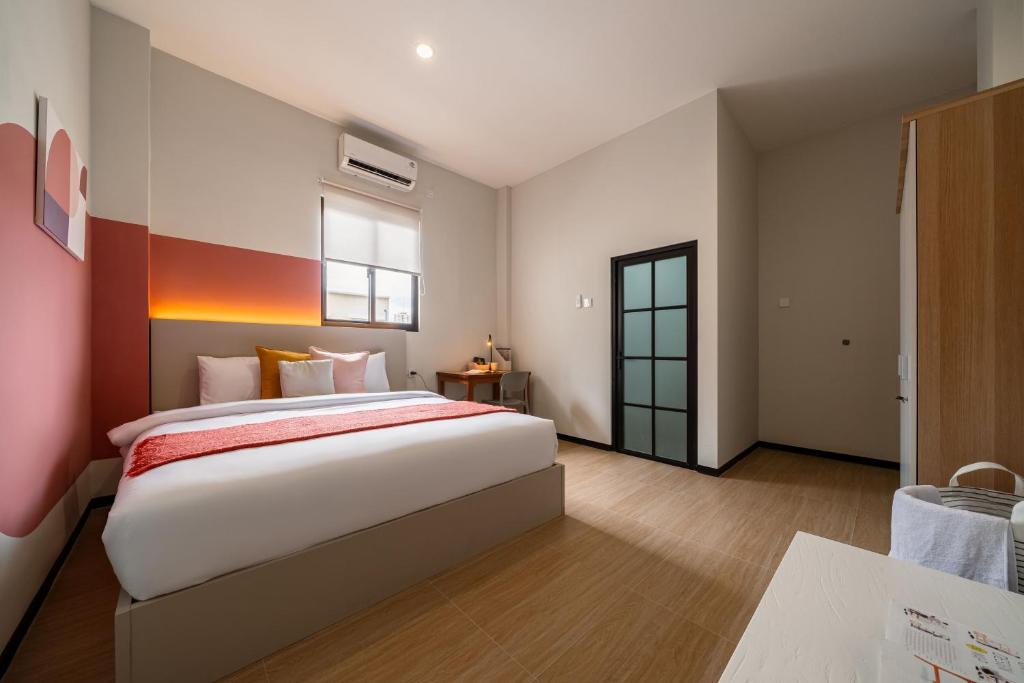 a bedroom with a large bed and a window at Cove Haven in Surabaya