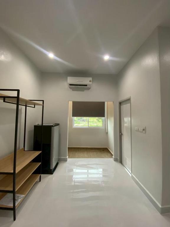 an empty room with a staircase and a window at PRIMENINe in Ban Ru Sa Mi Lae