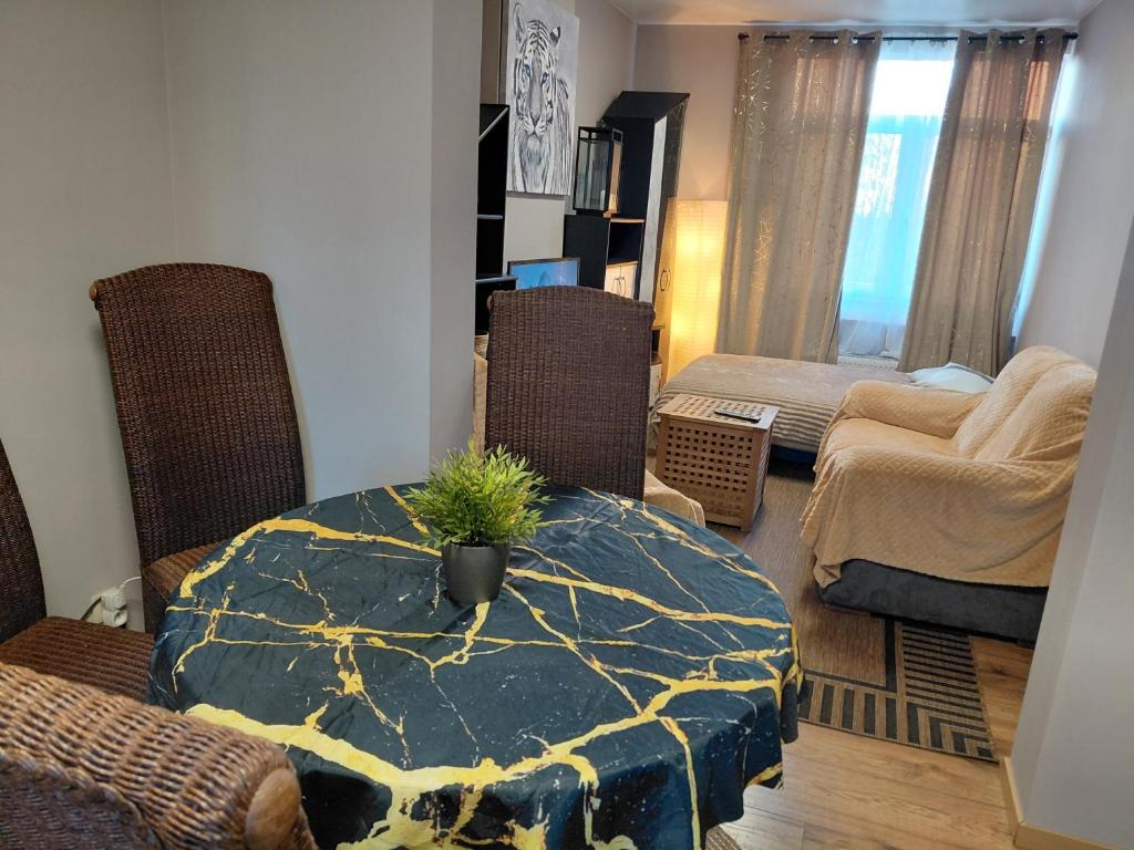 a living room with a table with a potted plant on it at Sunny Days Cozy and Comfortable Apartment in Boutersem