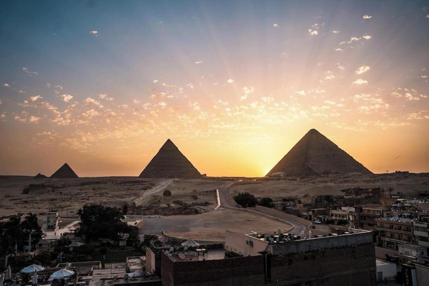 a view of the pyramids of giza at sunset at Egypt Pyramids Hotel in Cairo