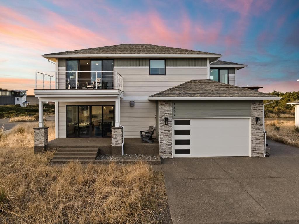 a house with a white garage in a field at The Oceanview Retreat in Westport