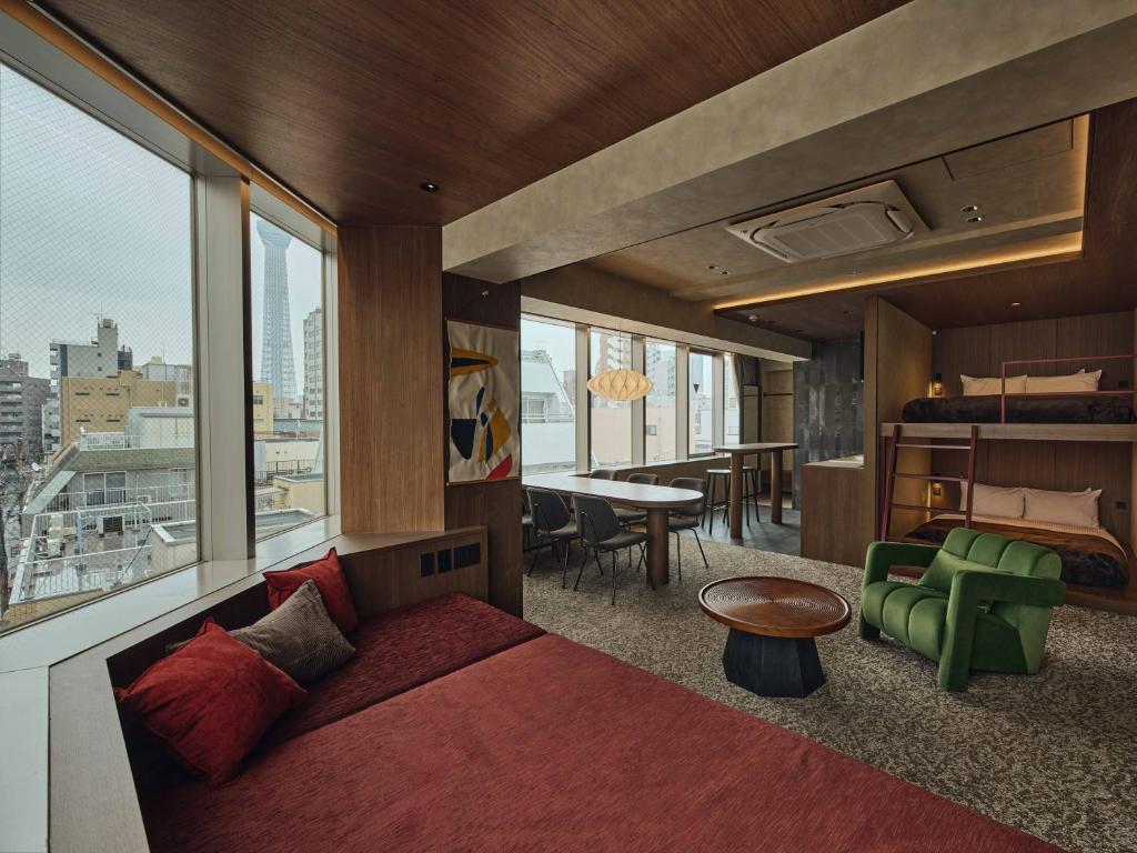 a bedroom with a bed and a view of a city at illi Haku Asakusa in Tokyo