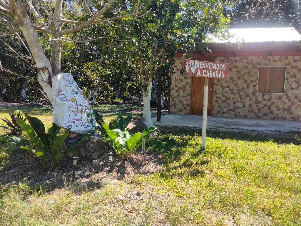 a sign in front of a building with a sign at koten Naj Cabanas in Xpujil