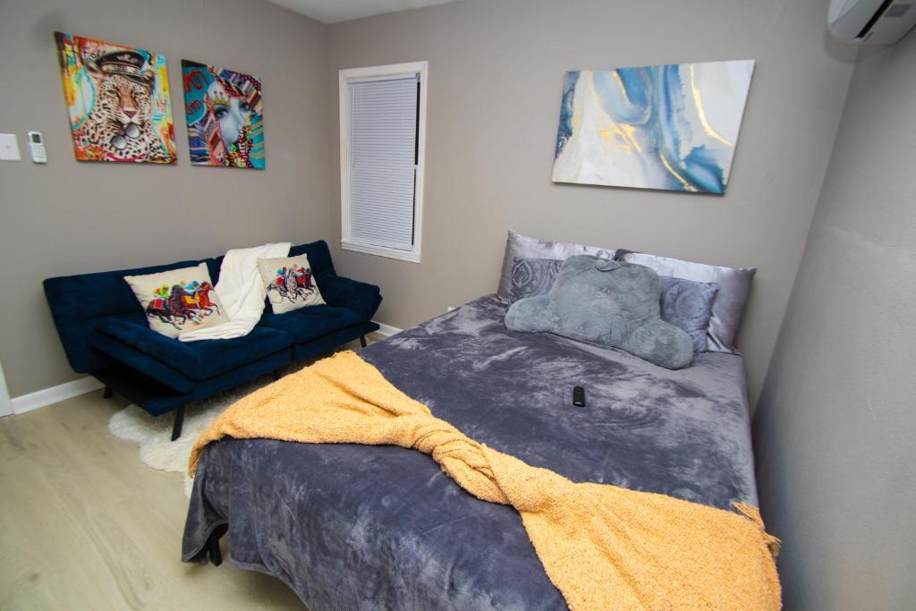 a bedroom with a bed and a couch at Home Sweet Home Bungalow in North Little Rock