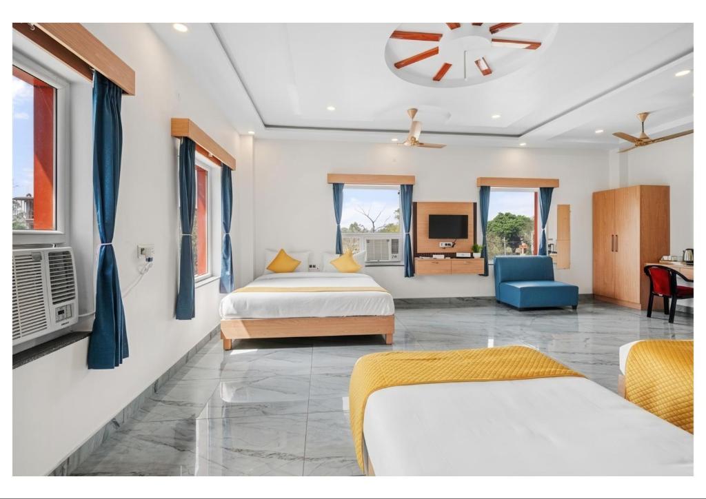 a hotel room with two beds and a tv at RS Resort in Ayodhya