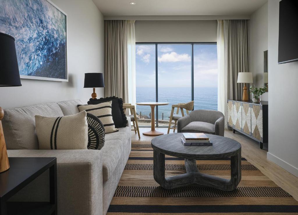 a living room with a couch and a table at Alila Marea Beach Resort Encinitas, a Hyatt Resort in Encinitas