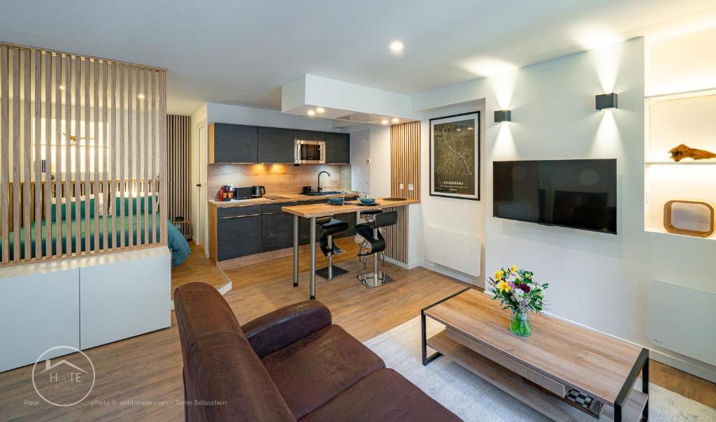 a living room with a couch and a table at Studio neuf et moderne centre historique in Chambéry