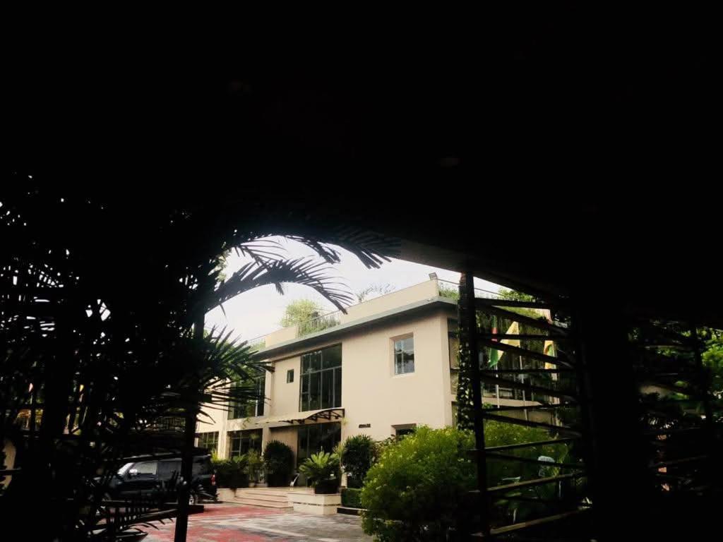 a building with a palm tree in front of it at Love Couple in Dhaka