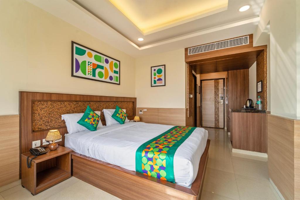 a bedroom with a large bed in a room at Treebo Viswa Vikas Residency in Coimbatore