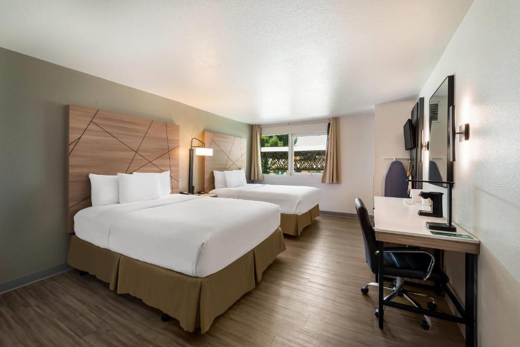 a hotel room with two beds and a desk at Quality Inn Yuba City-Marysville in Yuba City