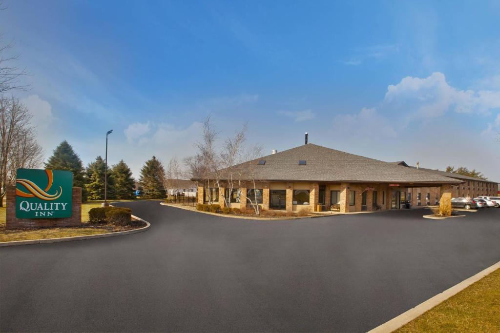 a building with a sign in the middle of a road at Quality Inn Marshall near I-69 in Marshall