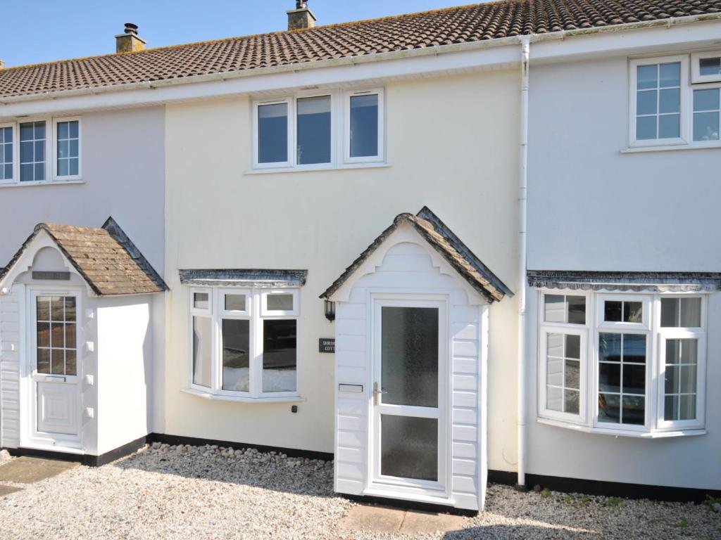 a white house with white doors and windows at Shrimper's Cottage in Wadebridge