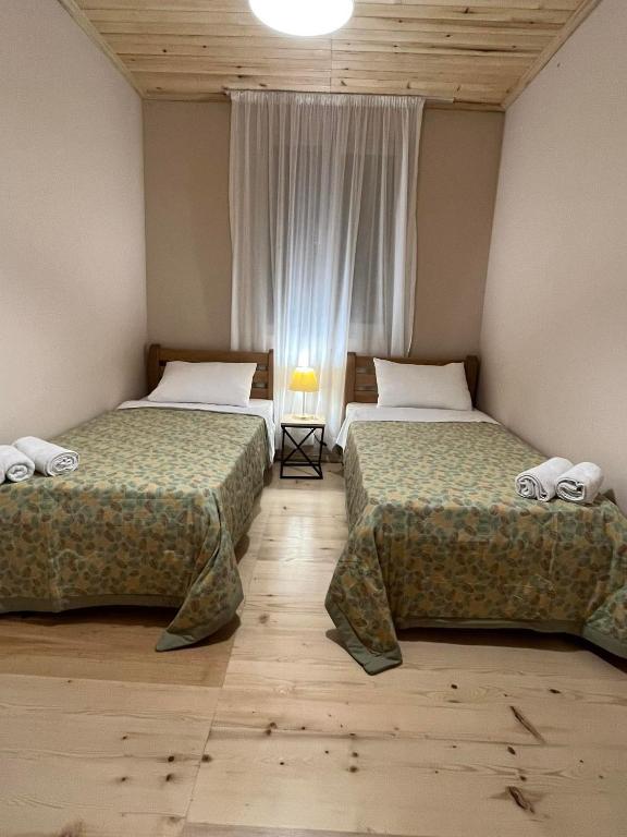 two beds sitting next to each other in a room at Apartments Gabliani in Mestia in Mestia