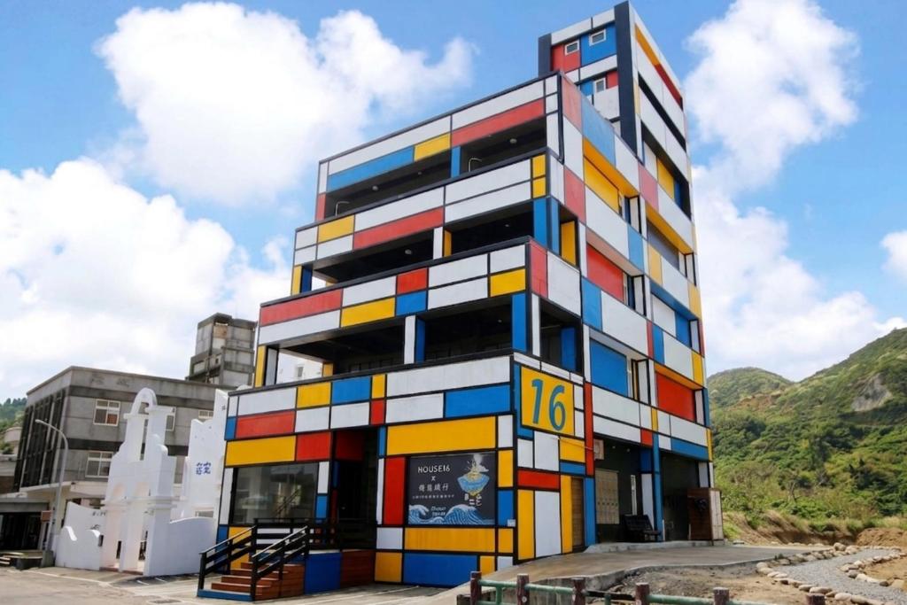 a building clad in colorful paint at House16 in Green Island