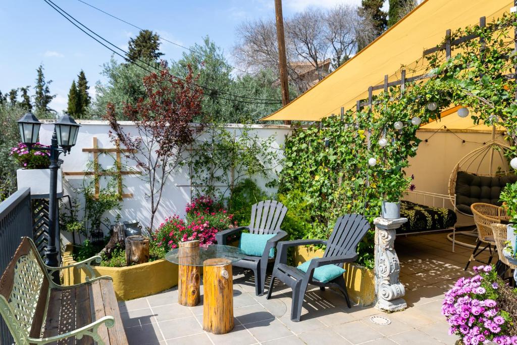 a patio with chairs and tables and flowers at Apartamento amplio con gran terraza y vistas in Monachil