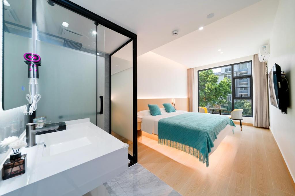 a bedroom with a bed and a sink and a mirror at Yangshuo YeQi Hotel in Yangshuo