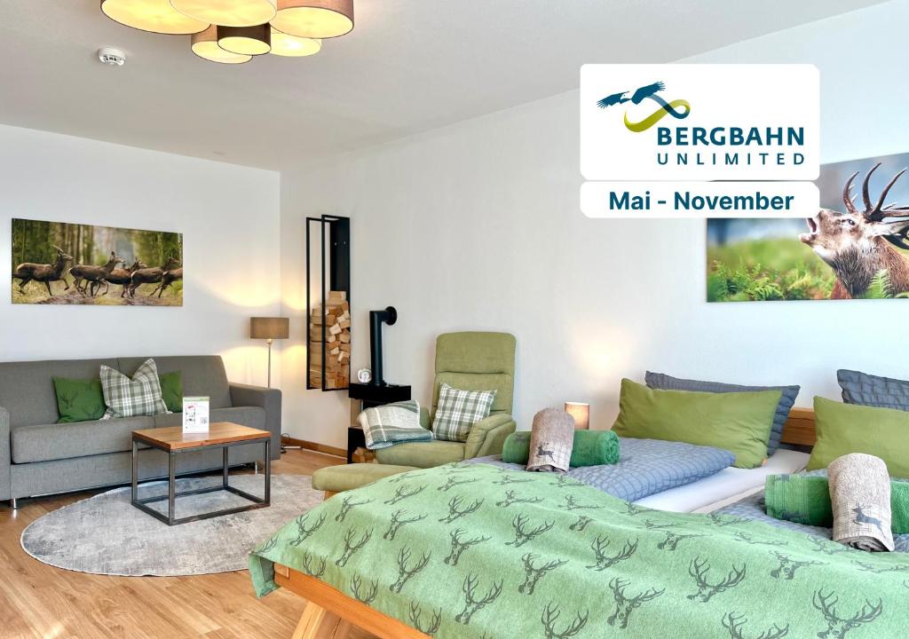 a living room with a bed and a couch at Hirschzauber A9 Montana Haus in Oberstdorf