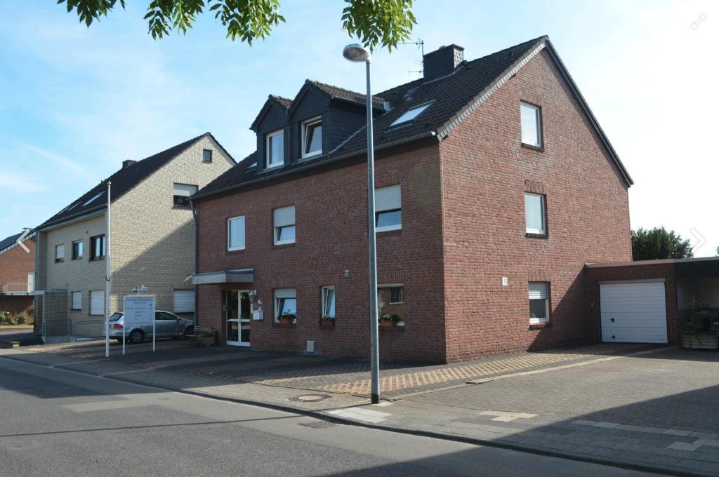 a large brick building with a street light in front of it at Frühstückspension Stenbrock in Grevenbroich