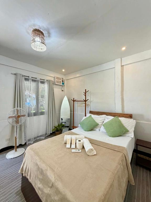 a bedroom with a large bed with towels on it at Namastay Siargao in General Luna