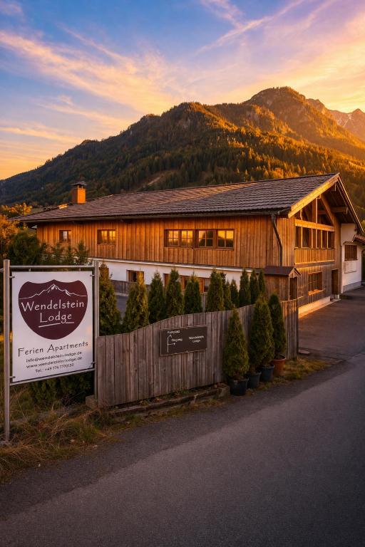 a building with a sign in front of it at GM-Stays Wendelstein Lodge - Sauna & Alpenblick - BRIGHT Collection in Fischbachau