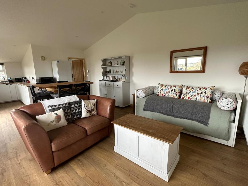 a living room with a couch and a table at The Apple Press in Williton